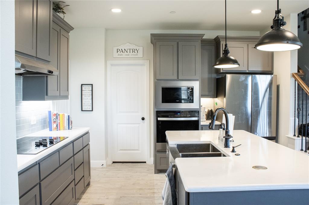 642 Sandiford Court Mansfield, TX 76063 - Photo 4 of 40 a kitchen with stainless steel appliances a stove a sink and a refrigerator