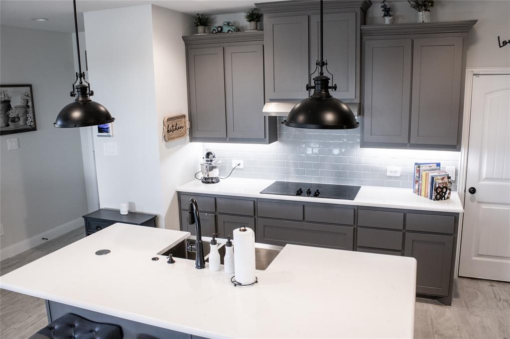 642 Sandiford Court Mansfield, TX 76063 - Photo 5 of 40 a kitchen with a table chairs and white cabinets
