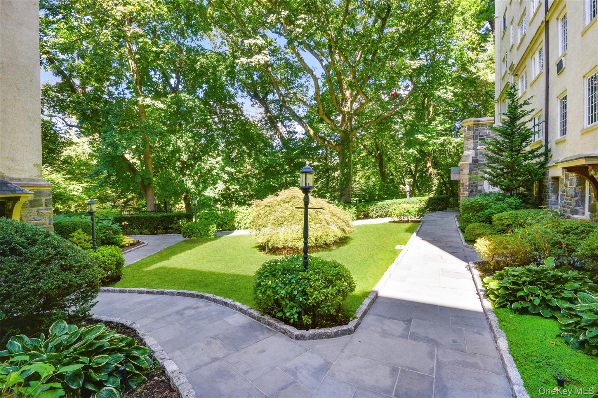 1 Rivermere, Unit 1G Bronxville, NY 10708 - Photo 2 of 24 View of home's community with a lawn