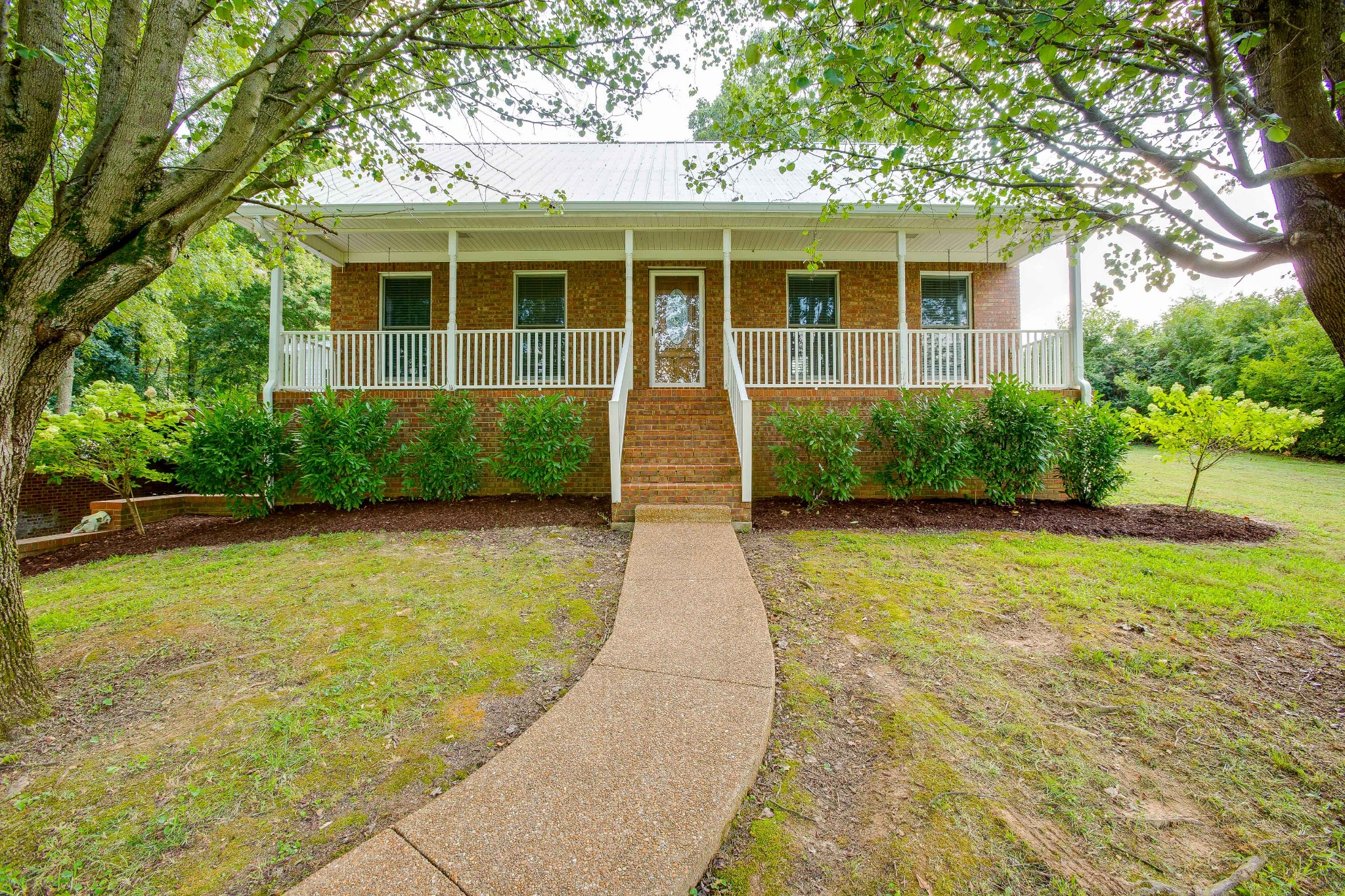 357 Blue Door Road Portland, TN 37148 - Photo 1 of 46 a front view of a house with garden