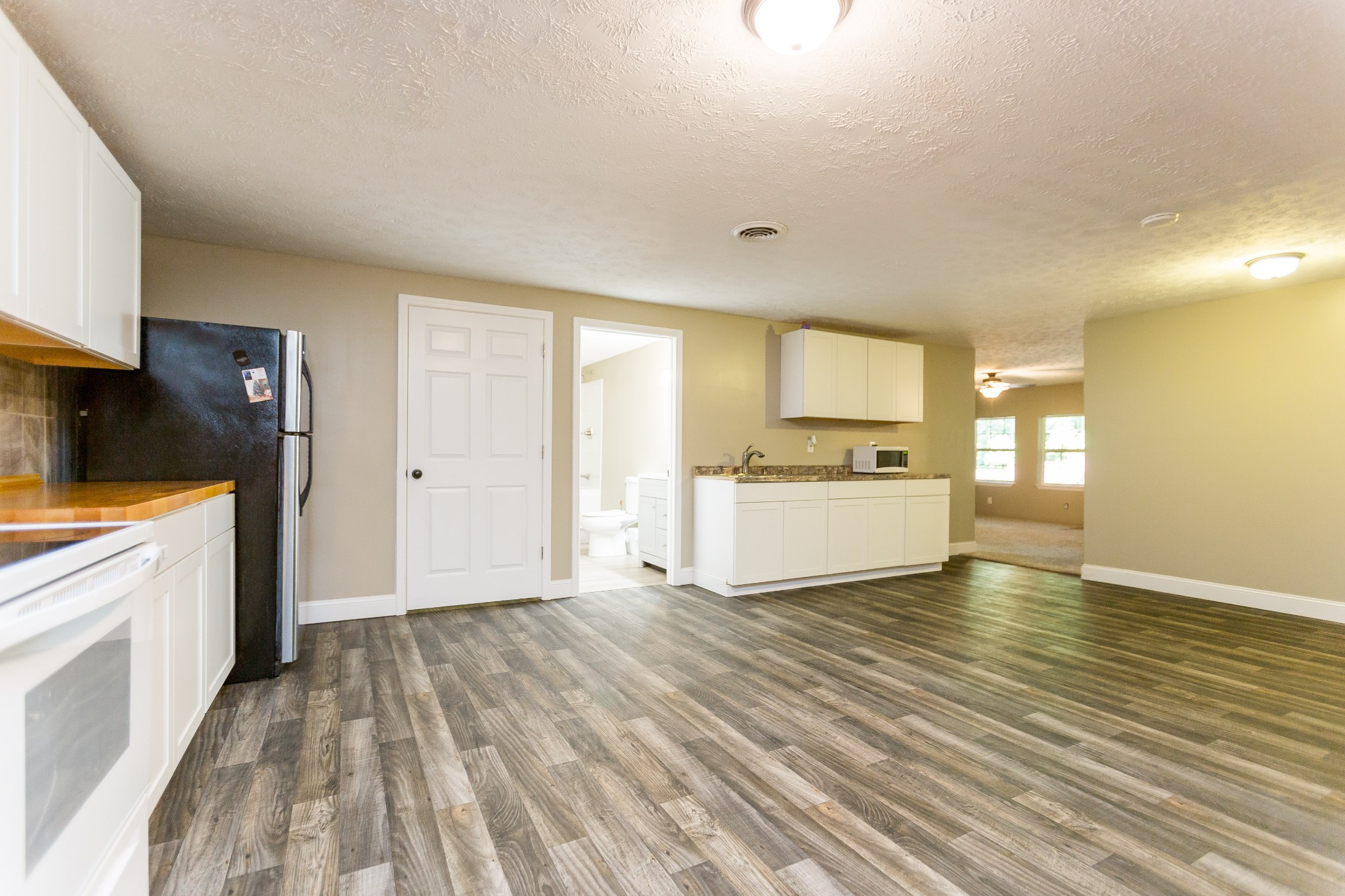 357 Blue Door Road Portland, TN 37148 - Photo 13 of 46 a large white kitchen with a sink a refrigerator and window