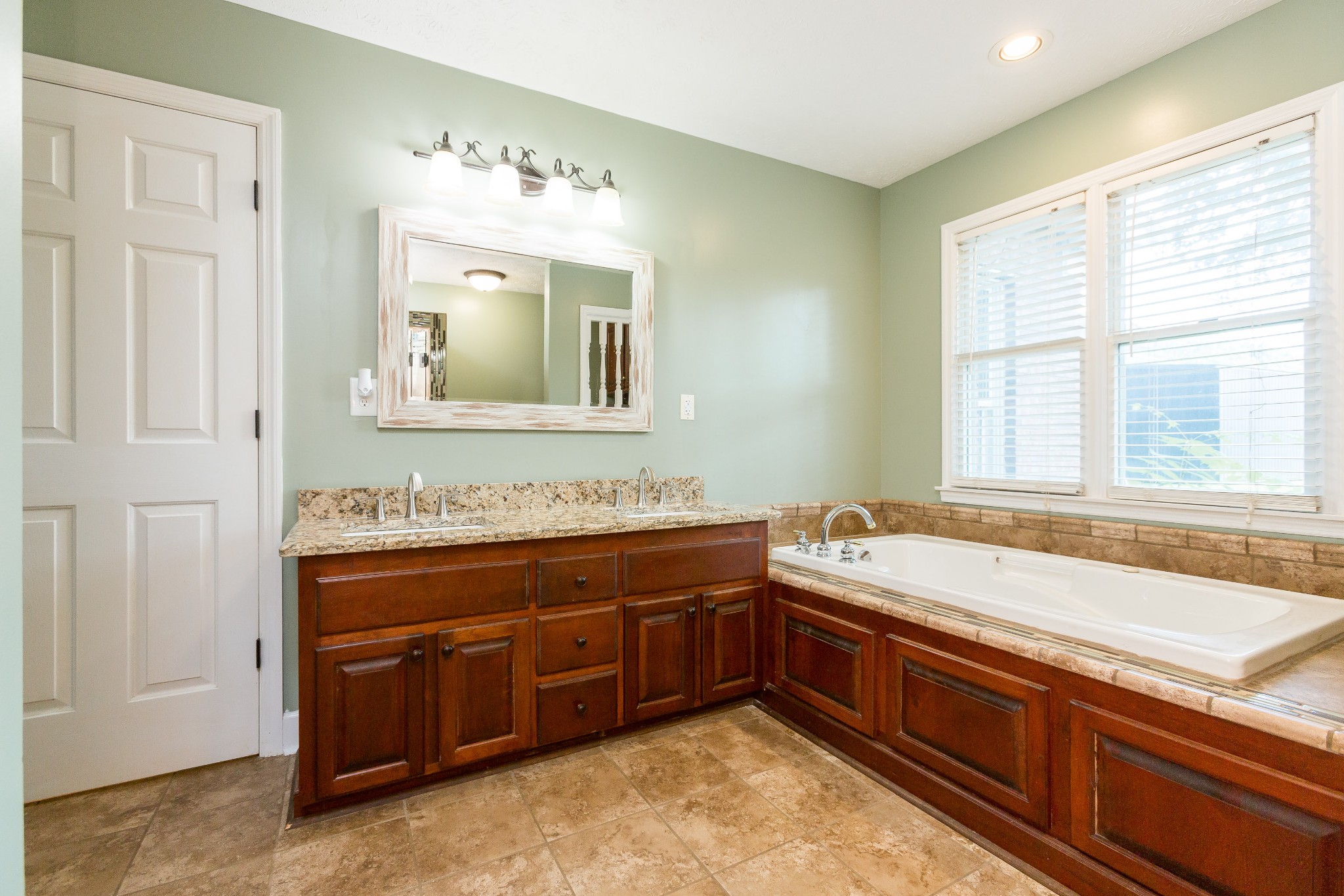 357 Blue Door Road Portland, TN 37148 - Photo 18 of 46 a spacious bathroom with a tub sink and mirror