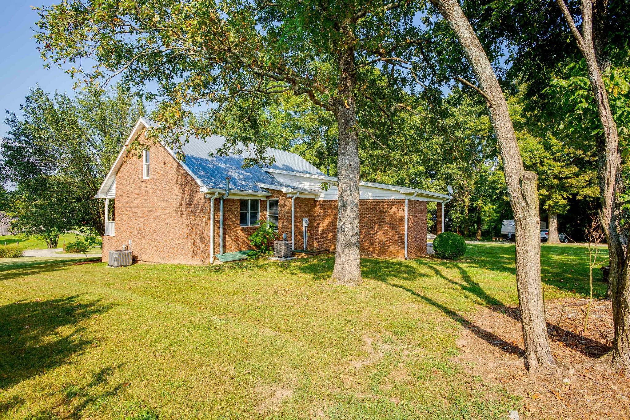 357 Blue Door Road Portland, TN 37148 - Photo 41 of 46 a view of a house with backyard and a tree