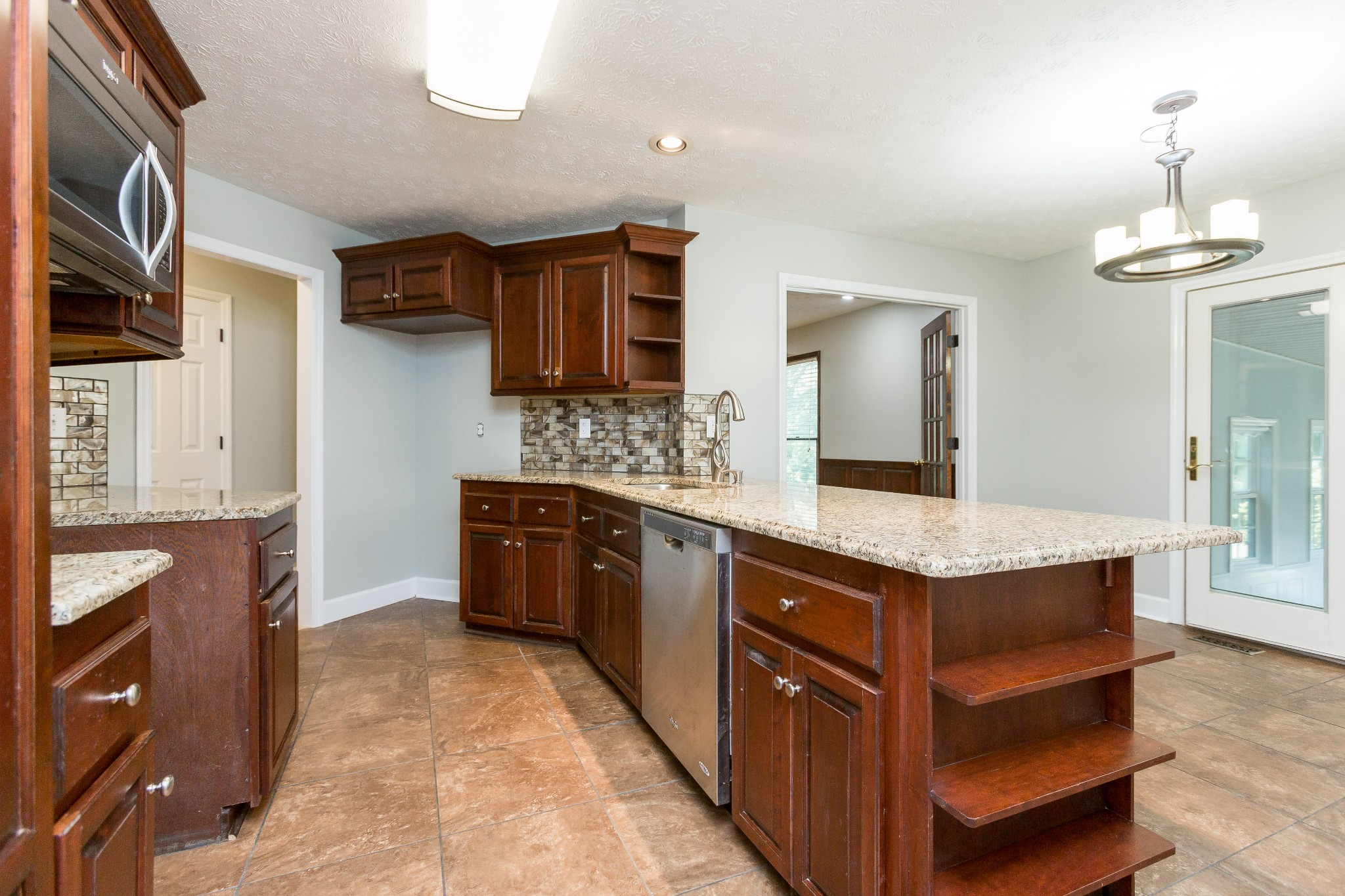357 Blue Door Road Portland, TN 37148 - Photo 9 of 46 a kitchen with stainless steel appliances granite countertop a stove a sink a refrigerator and a wooden cabinets