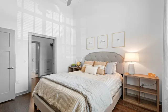 a bedroom with a bed and a night stand