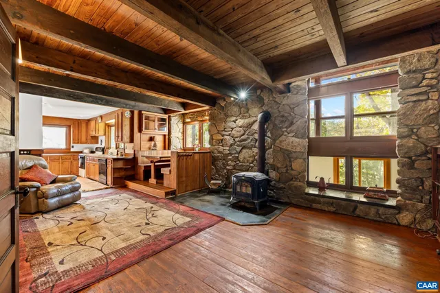 a view of a livingroom with furniture window and wooden floor