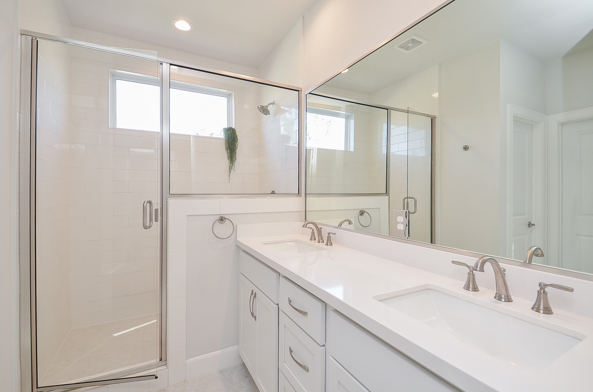 9577 Neuens Road, Unit F Houston, TX 77080 - Photo 18 of 26 Luxurious en-suite bath featuring dual vanities, quartz counters, and a spa-style oversized walk-in shower.