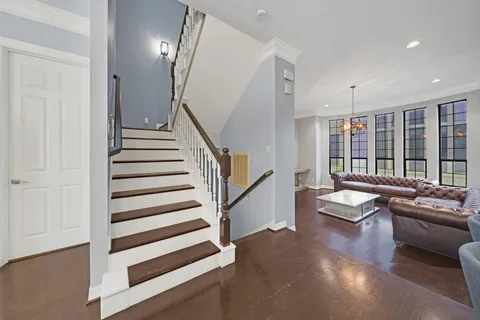a living room with furniture and stairs