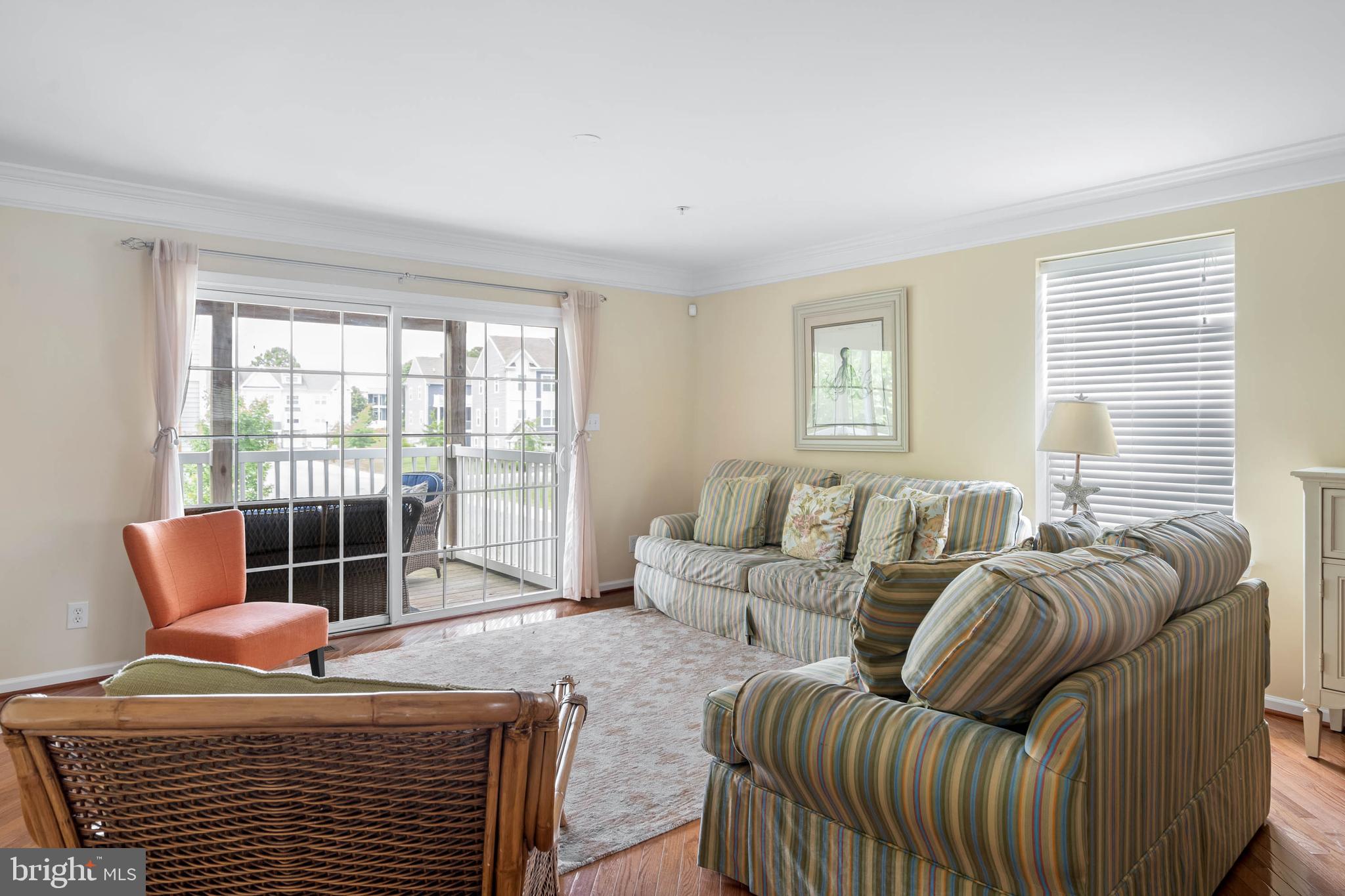 19901 Ames Drive, Unit 133 Rehoboth Beach, DE 19971 - Photo 11 of 34 a living room with furniture a wooden floor and next to a window