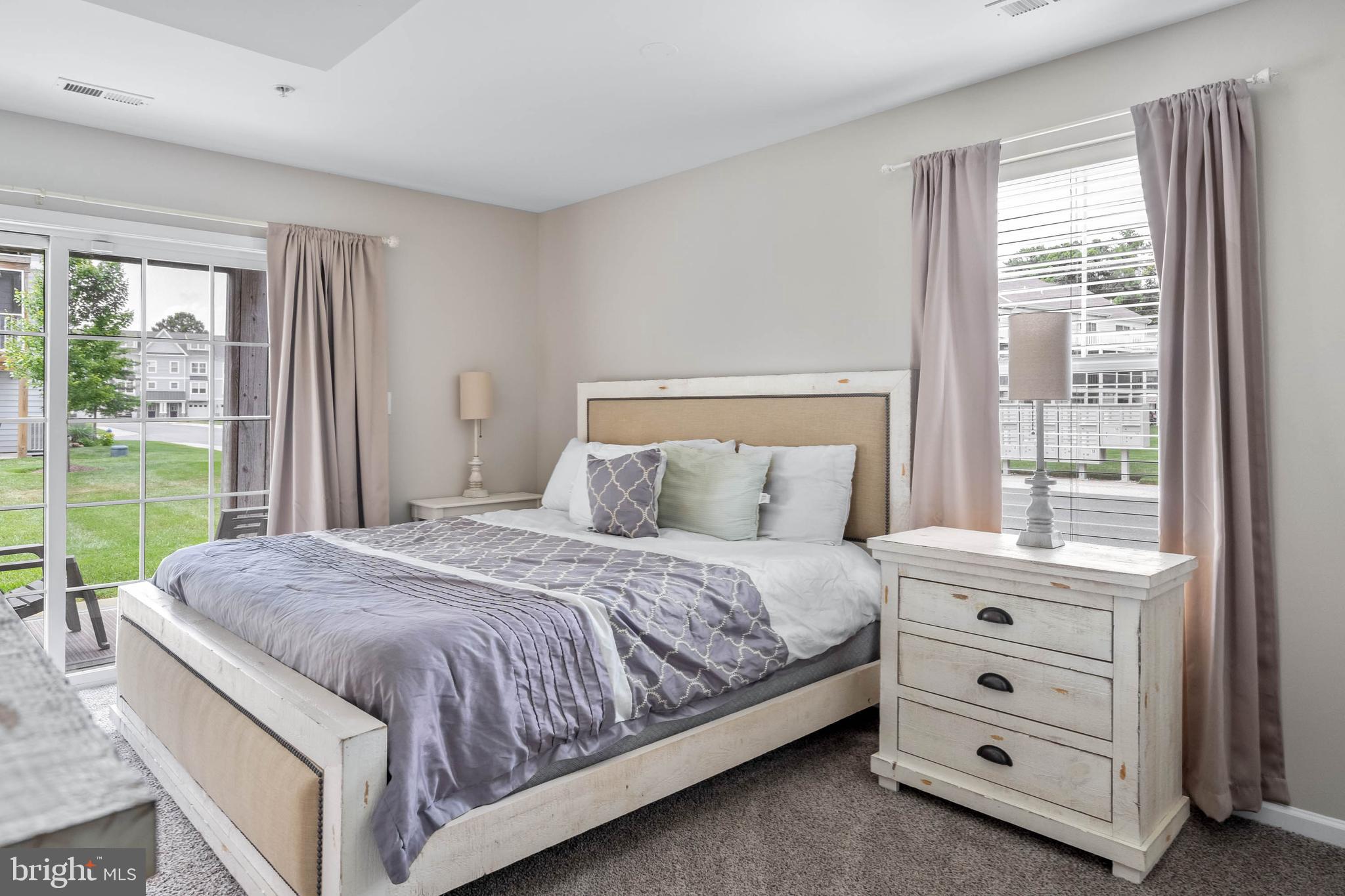 19901 Ames Drive, Unit 133 Rehoboth Beach, DE 19971 - Photo 16 of 34 a bedroom with a bed and a large window