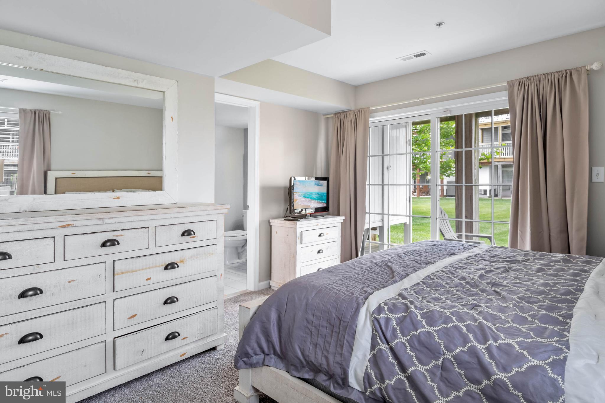 19901 Ames Drive, Unit 133 Rehoboth Beach, DE 19971 - Photo 17 of 34 a bedroom with a large bed and a window