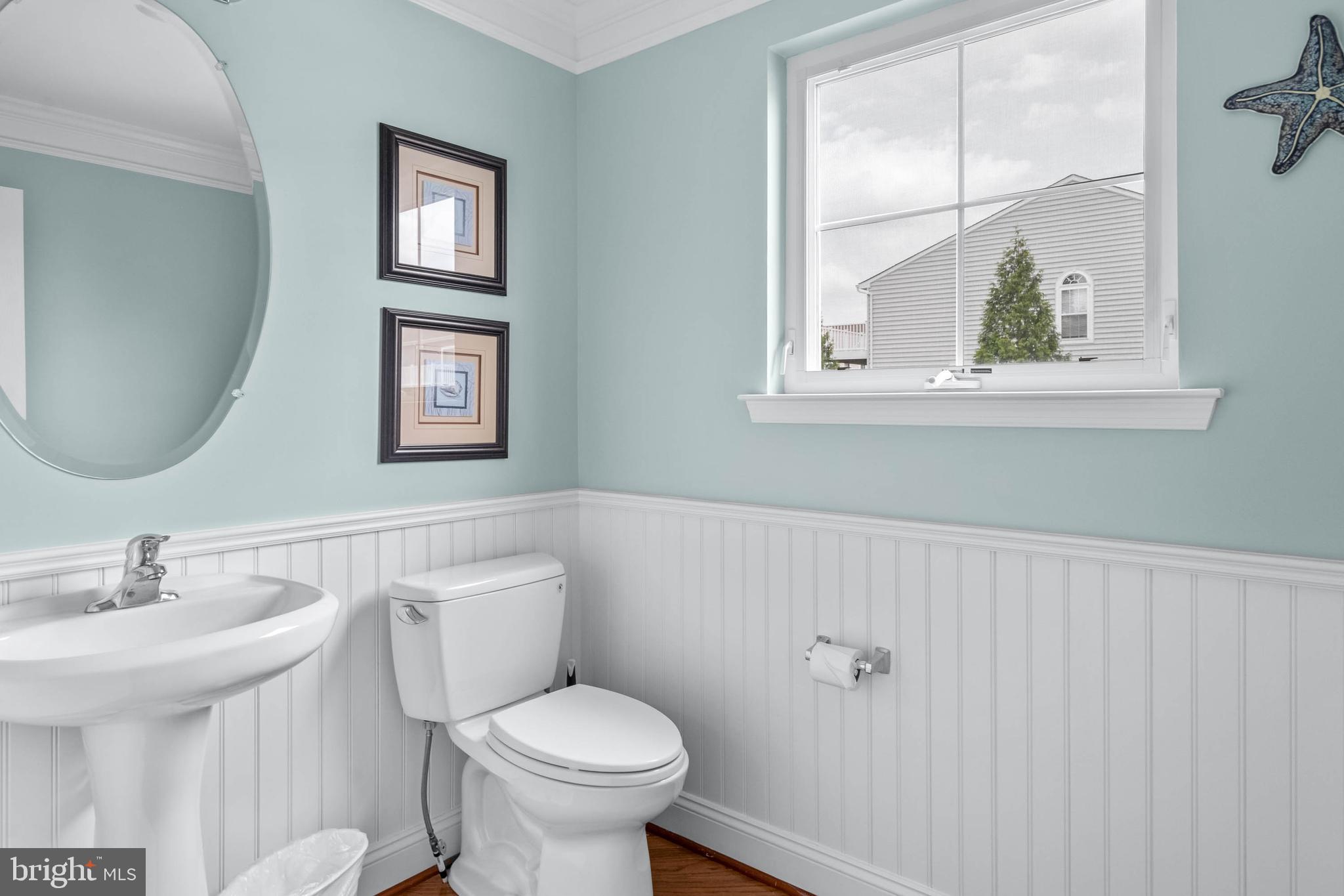 19901 Ames Drive, Unit 133 Rehoboth Beach, DE 19971 - Photo 18 of 34 a bathroom with a toilet sink and mirror