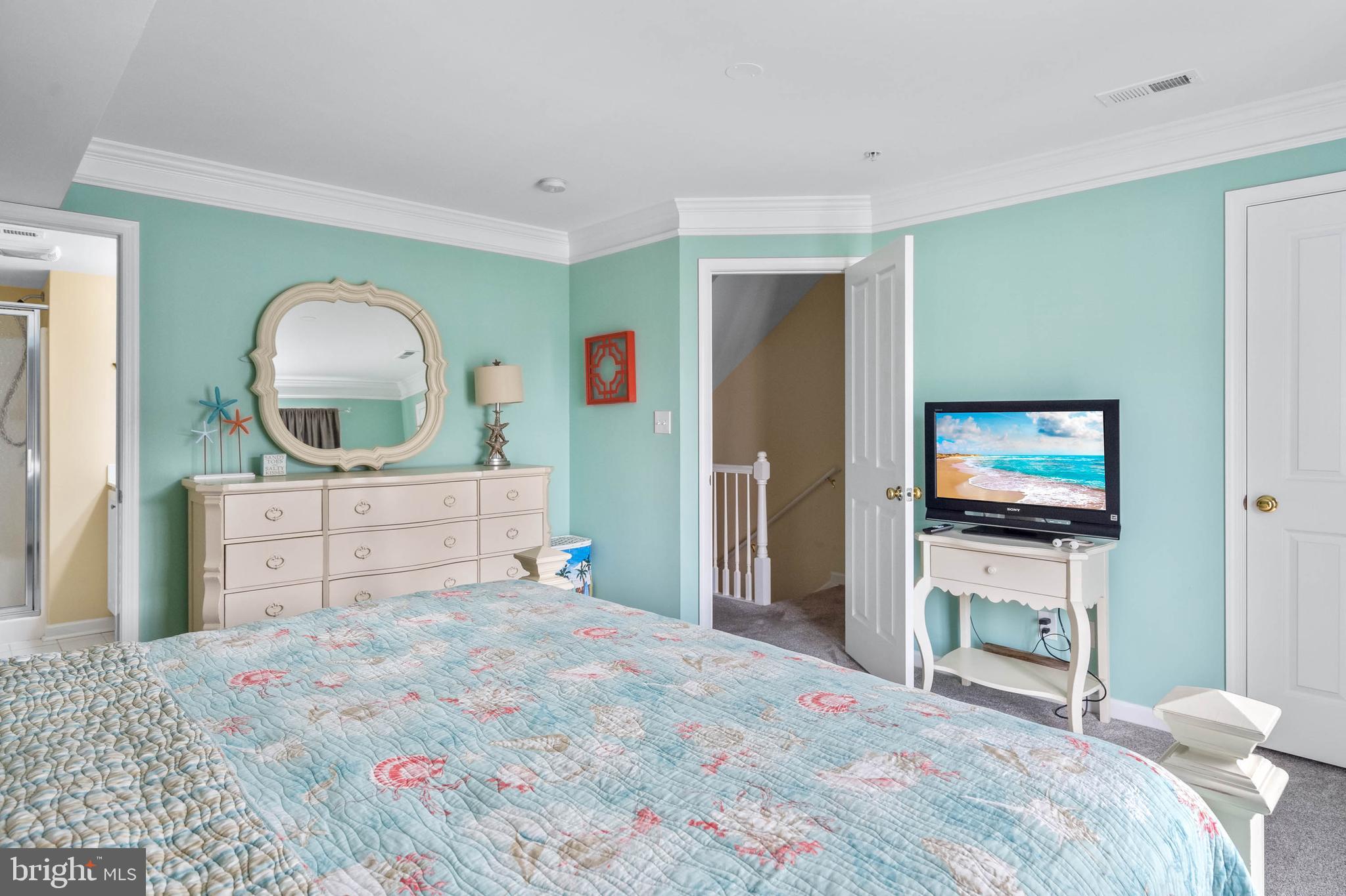 19901 Ames Drive, Unit 133 Rehoboth Beach, DE 19971 - Photo 20 of 34 a bedroom with a bed and a flat screen tv