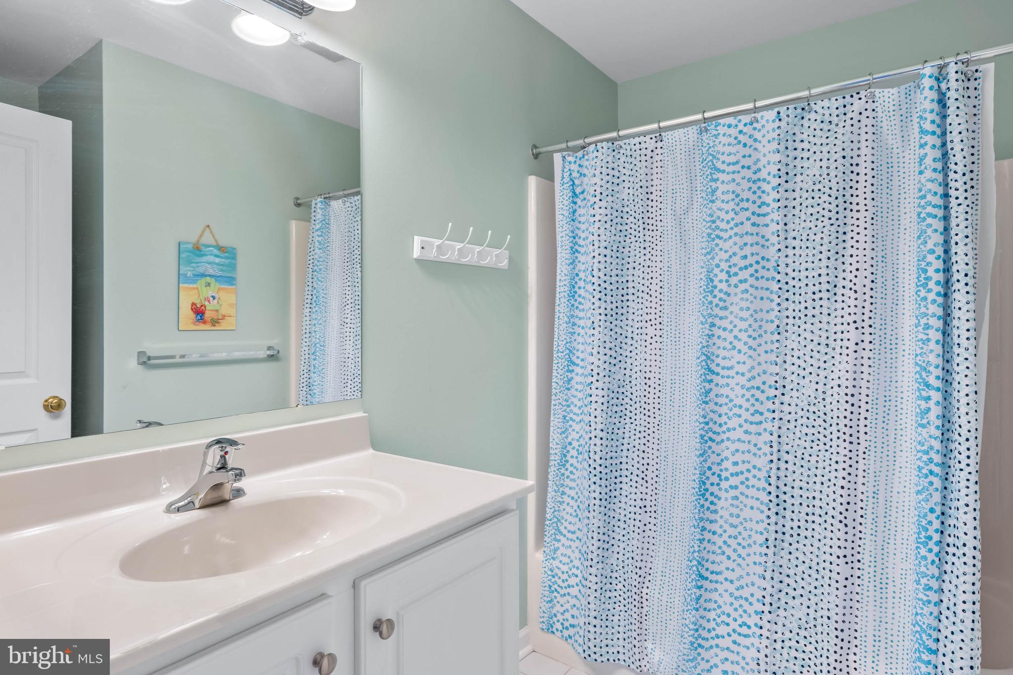 19901 Ames Drive, Unit 133 Rehoboth Beach, DE 19971 - Photo 24 of 34 a bathroom with a sink and a mirror