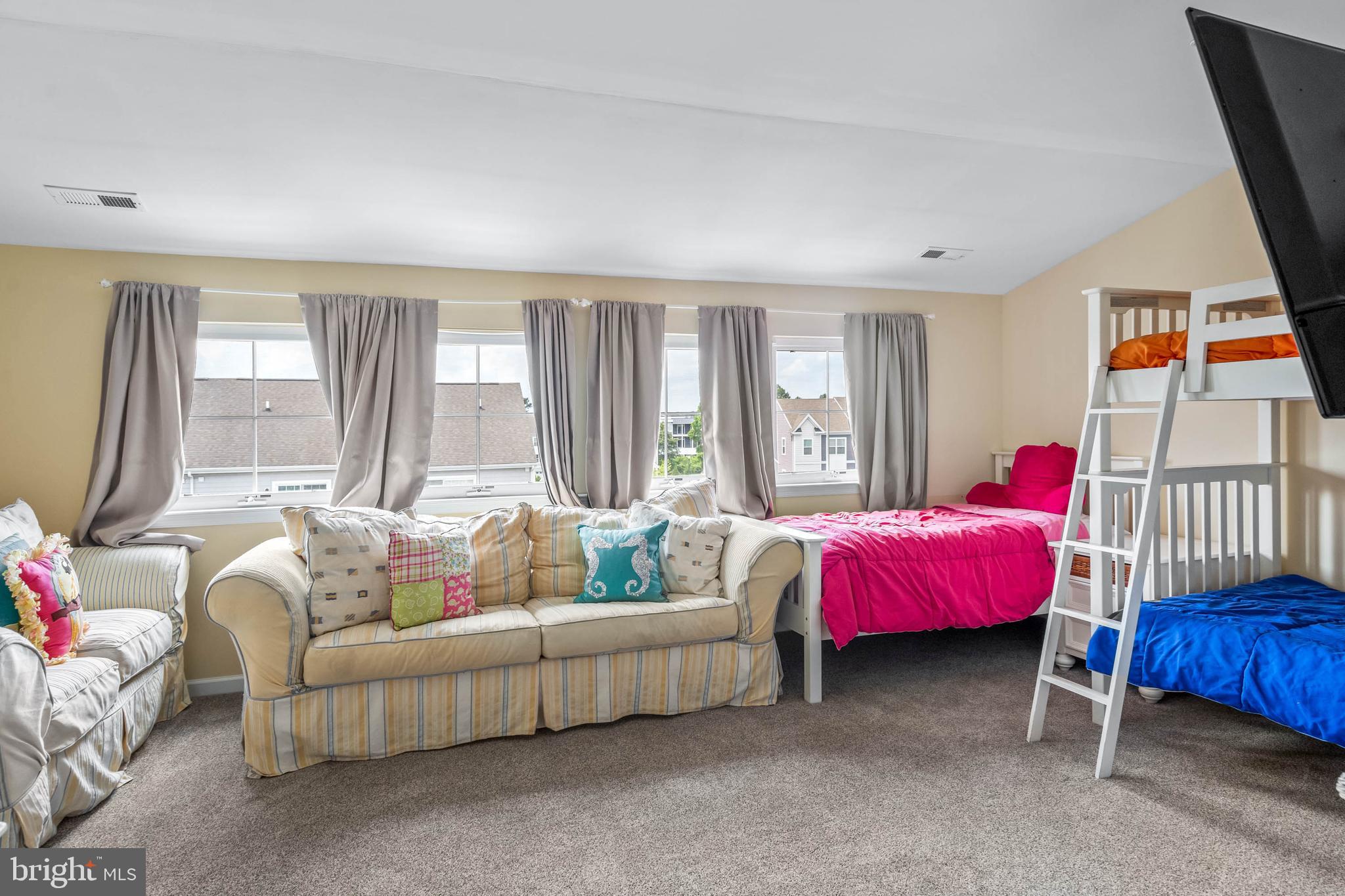 19901 Ames Drive, Unit 133 Rehoboth Beach, DE 19971 - Photo 25 of 34 a living room with furniture and a large window