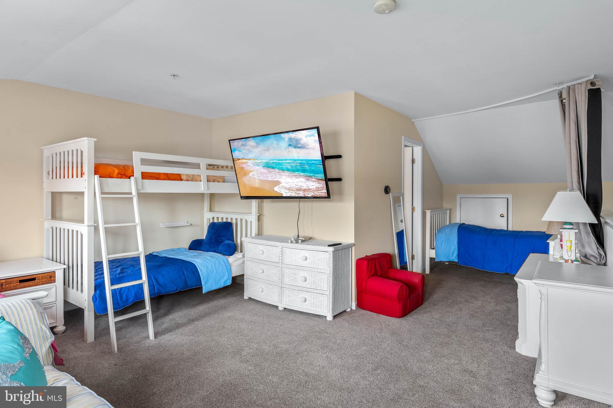 19901 Ames Drive, Unit 133 Rehoboth Beach, DE 19971 - Photo 26 of 34 a bedroom with furniture and a flat screen tv