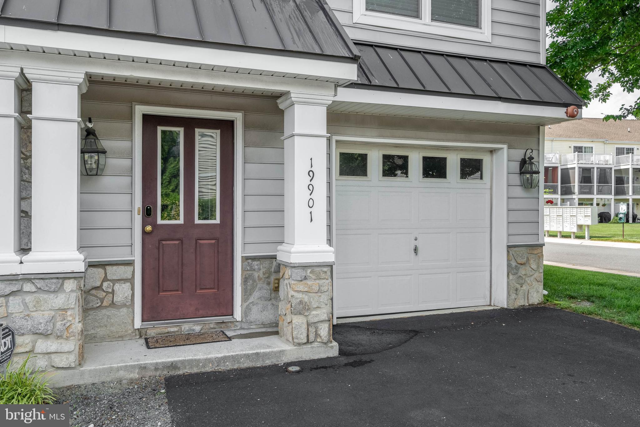 19901 Ames Drive, Unit 133 Rehoboth Beach, DE 19971 - Photo 3 of 34 a front view of a house with a garden