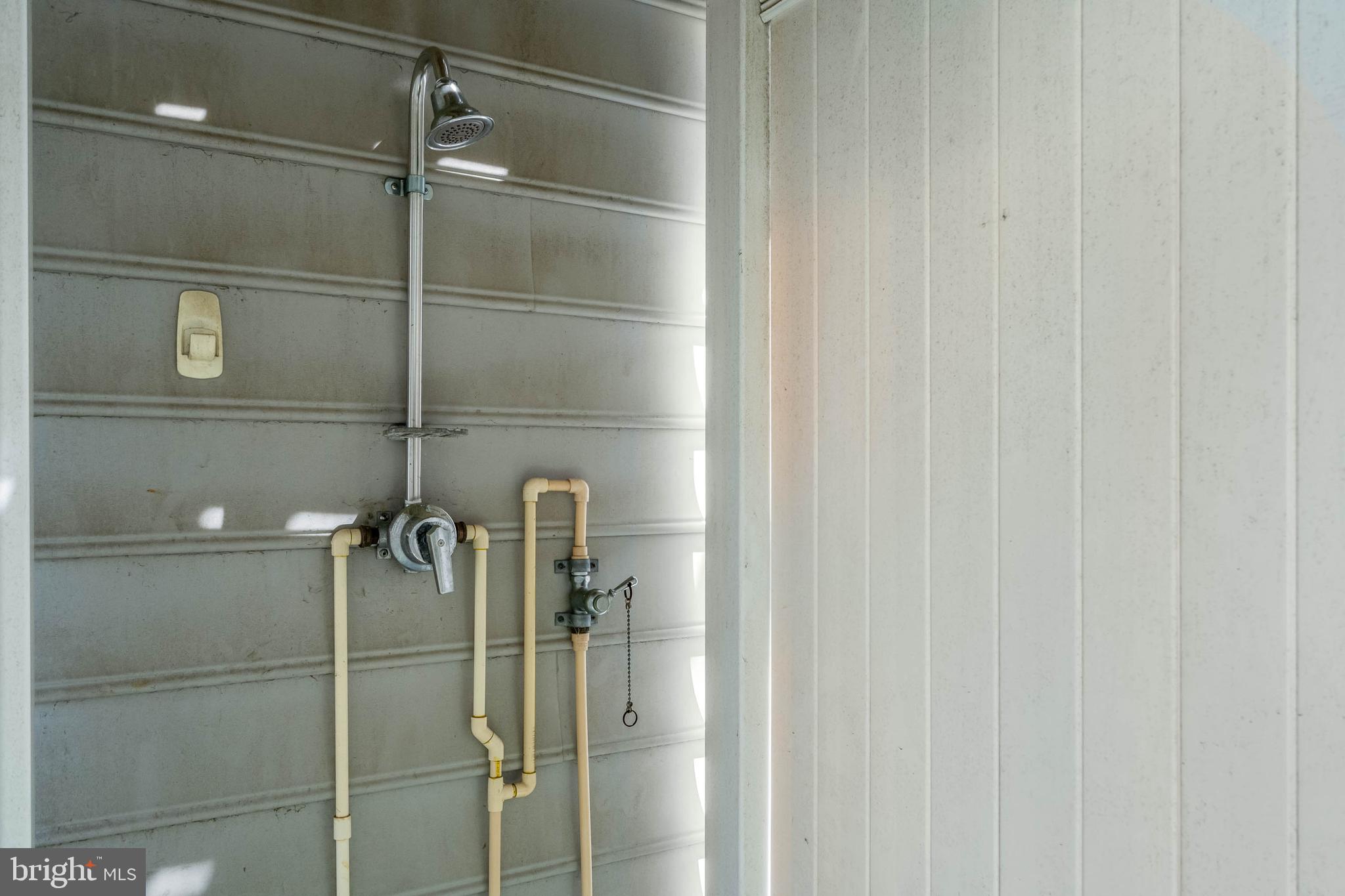 19901 Ames Drive, Unit 133 Rehoboth Beach, DE 19971 - Photo 31 of 34 a bathroom with a shower