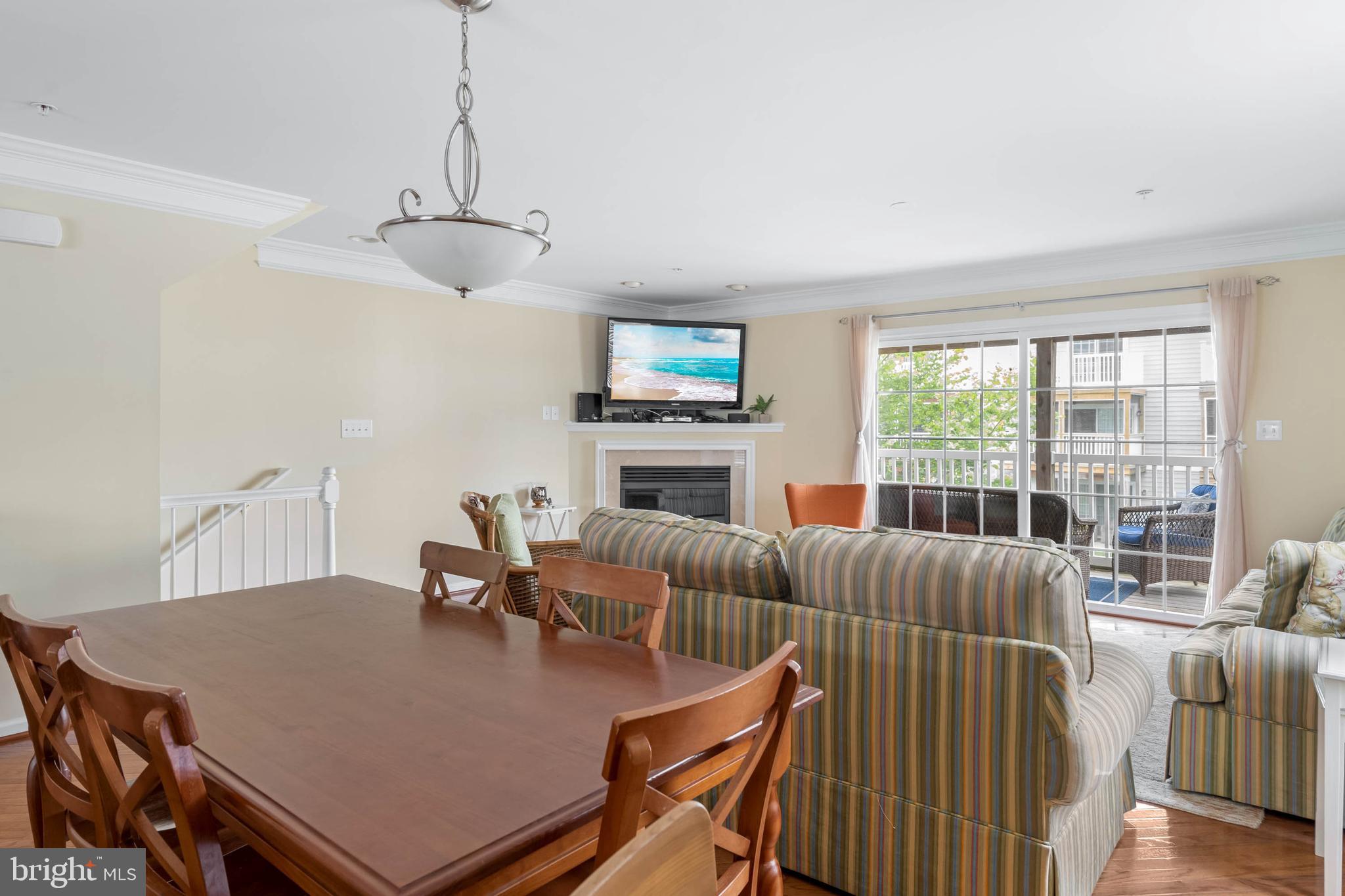 19901 Ames Drive, Unit 133 Rehoboth Beach, DE 19971 - Photo 9 of 34 a living room with furniture a large window and a fireplace