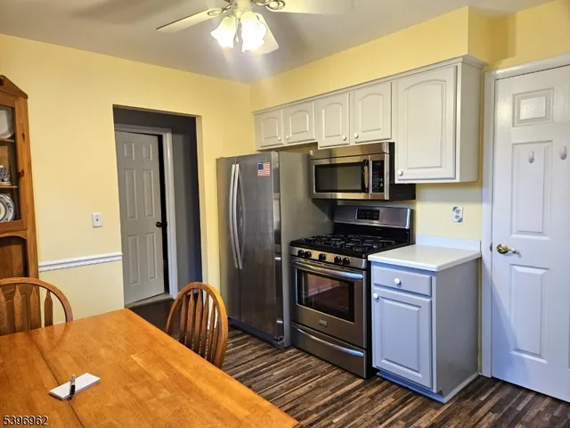 a kitchen with stainless steel appliances a stove microwave and refrigerator