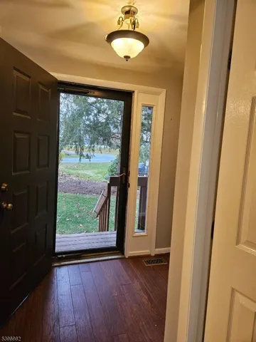 a view of a room with wooden floor and a window