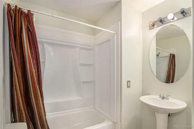 a bathroom with a sink a mirror and a bathtub