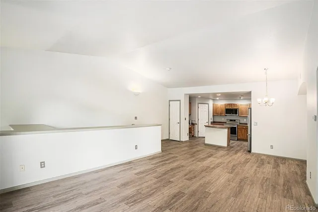 a kitchen with a refrigerator and a stove top oven