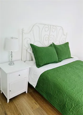 a bedroom with a bed and a night stand