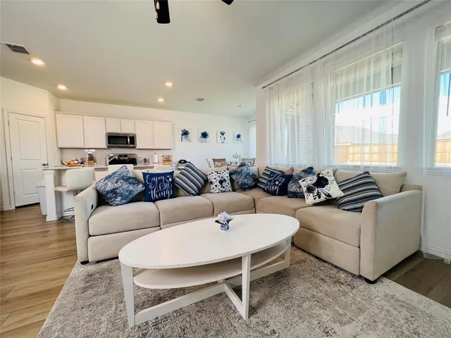 a living room with furniture and a large window