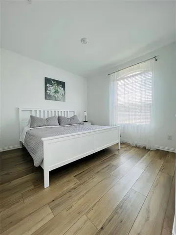 a spacious bedroom with a bed and a table