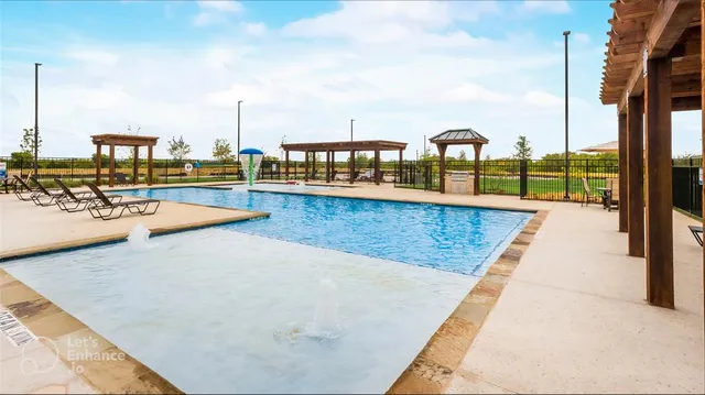 a view of a swimming pool with a lawn chairs