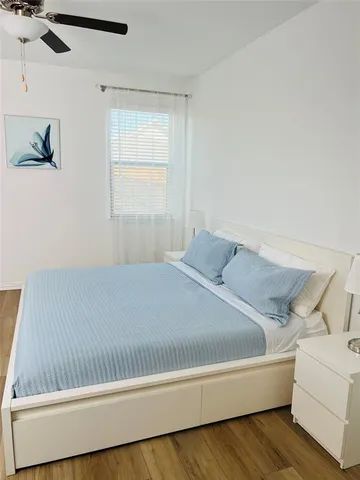 a bed sitting in a bedroom next to a window