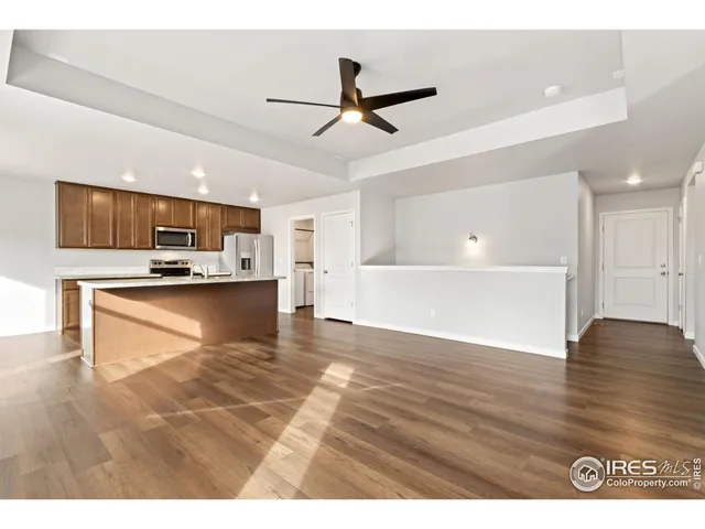 a view of kitchen with refrigerator microwave and cabinets
