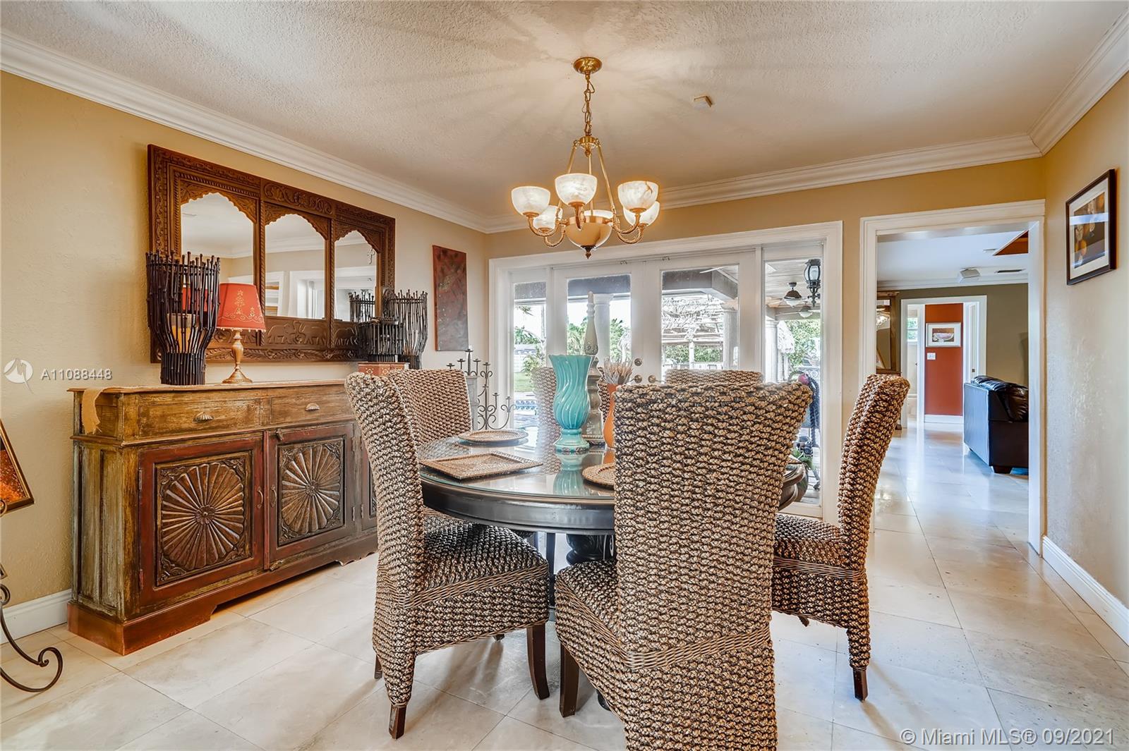 1851 Southwest 126th Court Miami, FL 33175 - Photo 16 of 27 a dining room with furniture a chandelier and window