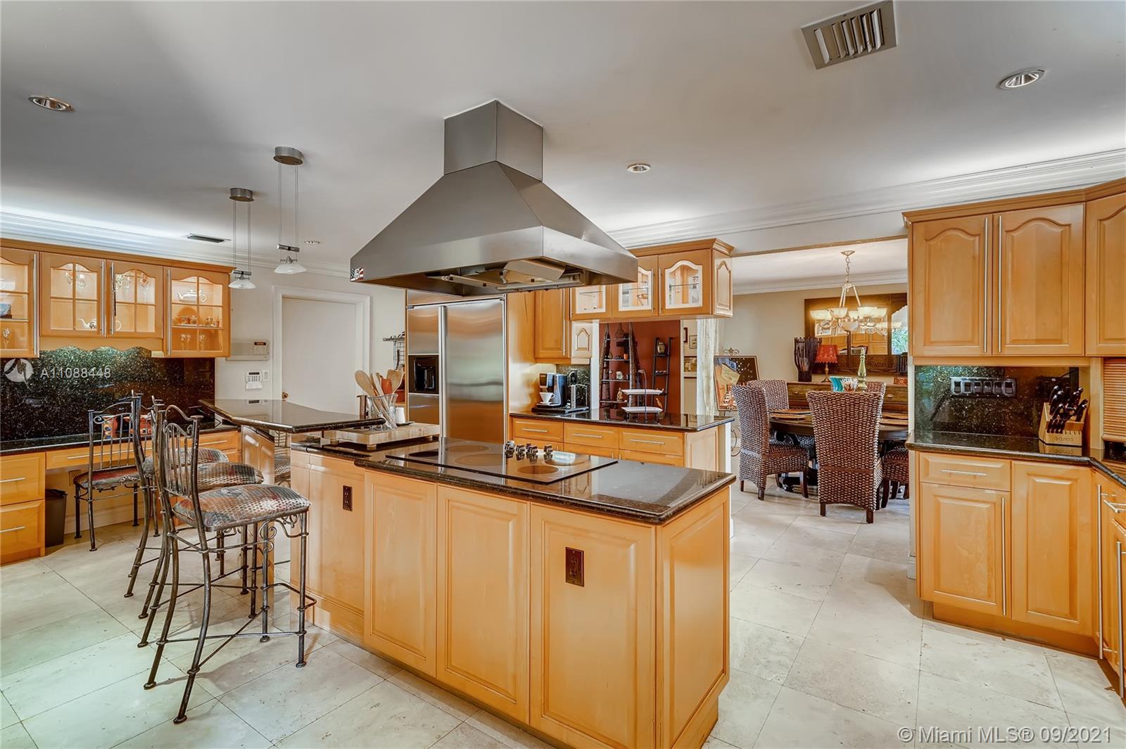 1851 Southwest 126th Court Miami, FL 33175 - Photo 18 of 27 a kitchen with stainless steel appliances a stove a sink a oven a dining table and chairs