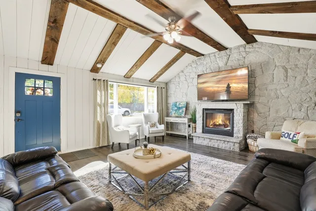 a living room with furniture a fireplace and a table