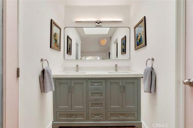 a bathroom with a sink vanity and mirror