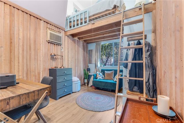 a living room with furniture a rug and a window