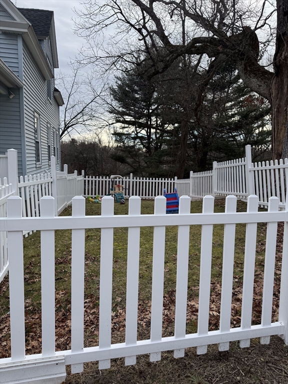 99 Clover Street Worcester, MA 01603 - Photo 3 of 8 a view of small yard with wooden fence