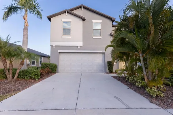 a front view of a house with a yard and garage