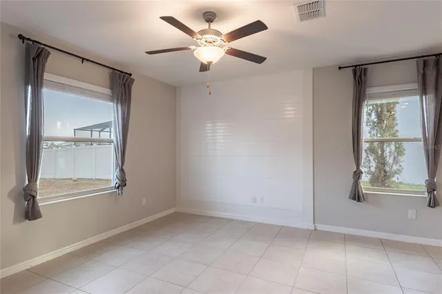a view of kitchen with kitchen island stainless steel appliances refrigerator stove microwave and cabinets