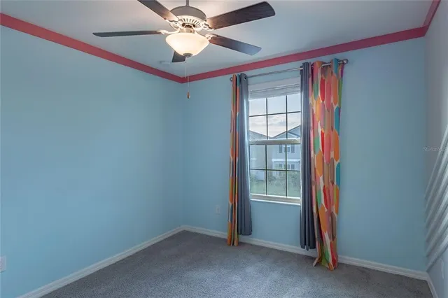 a bathroom with a window and a chandelier fan