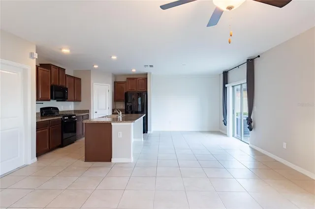 a kitchen with stainless steel appliances granite countertop a refrigerator oven a sink dishwasher and a refrigerator