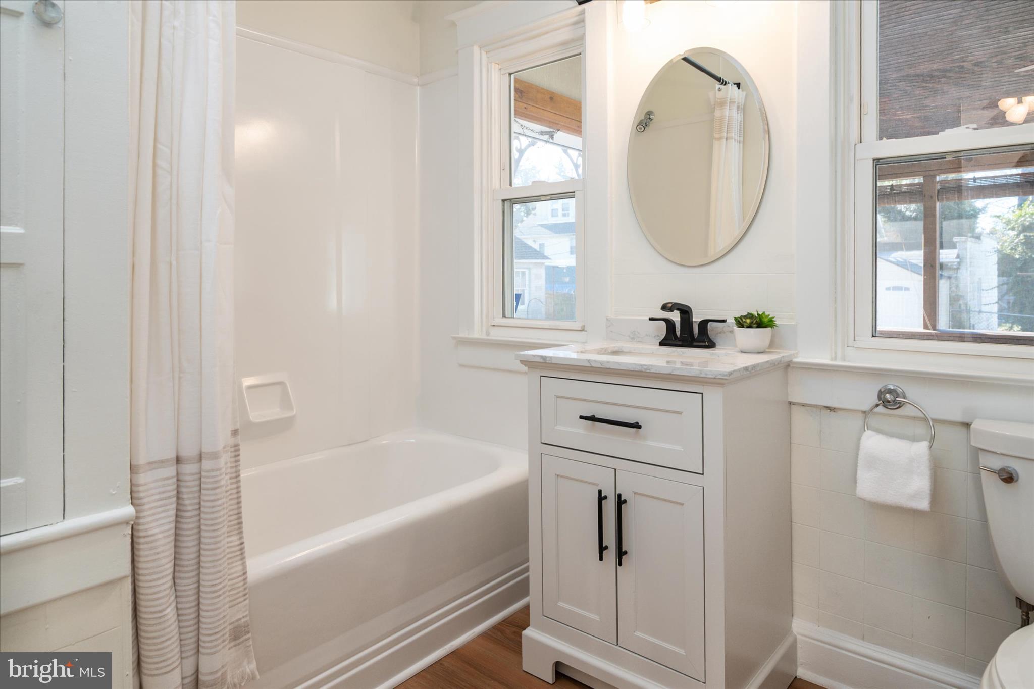 3827 Echodale Avenue Baltimore, MD 21206 - Photo 16 of 36 a bathroom with a sink mirror toilet and bathtub