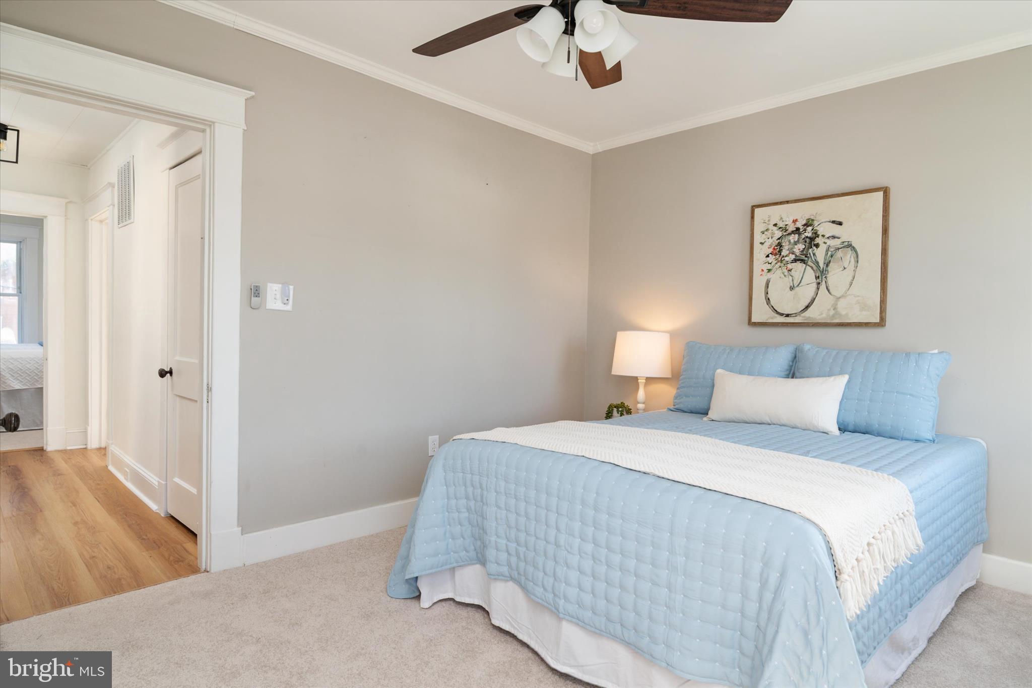 3827 Echodale Avenue Baltimore, MD 21206 - Photo 18 of 36 a bedroom with a bed and a chandelier