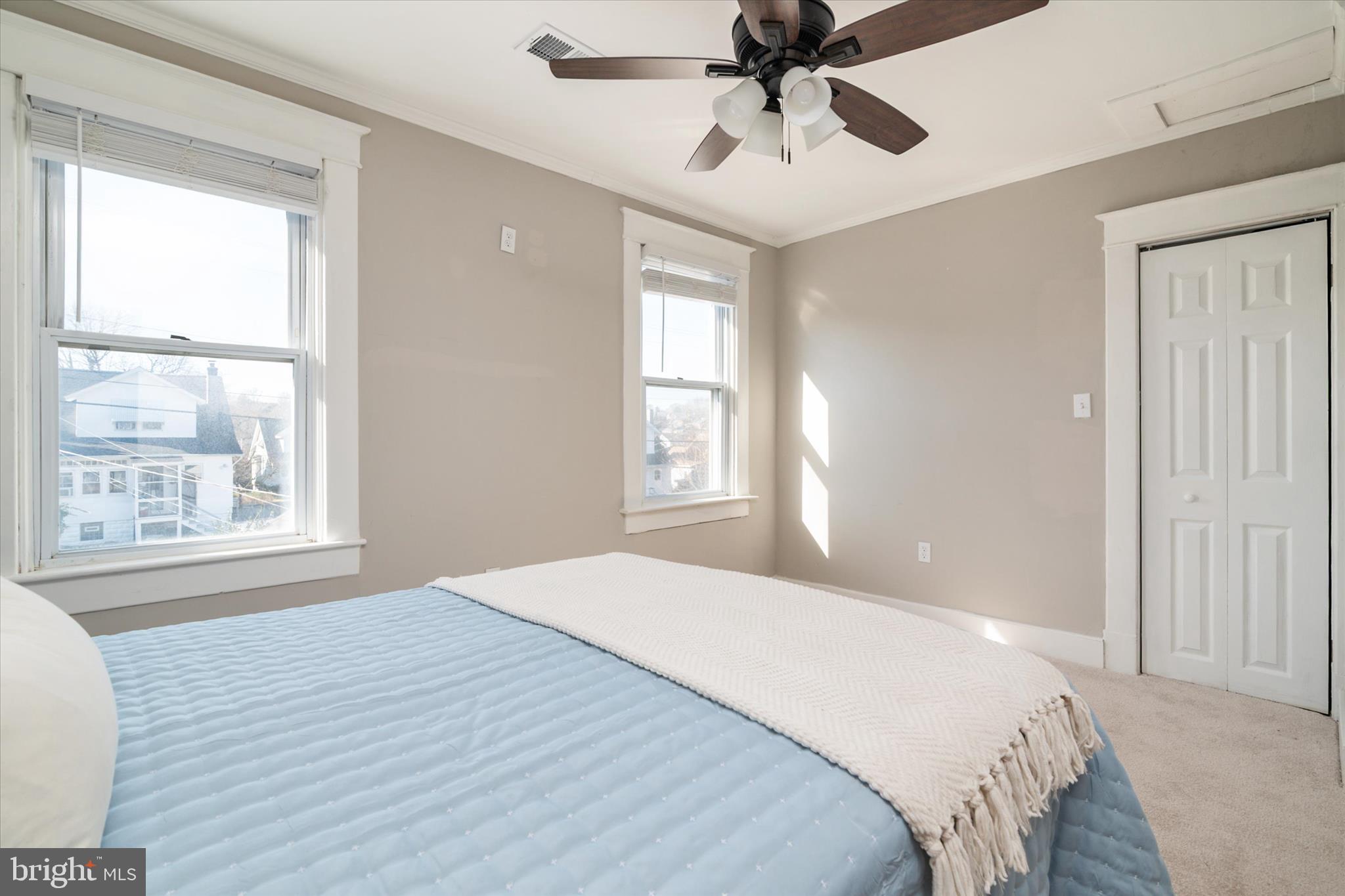 3827 Echodale Avenue Baltimore, MD 21206 - Photo 19 of 36 a bedroom with a large bed and a window