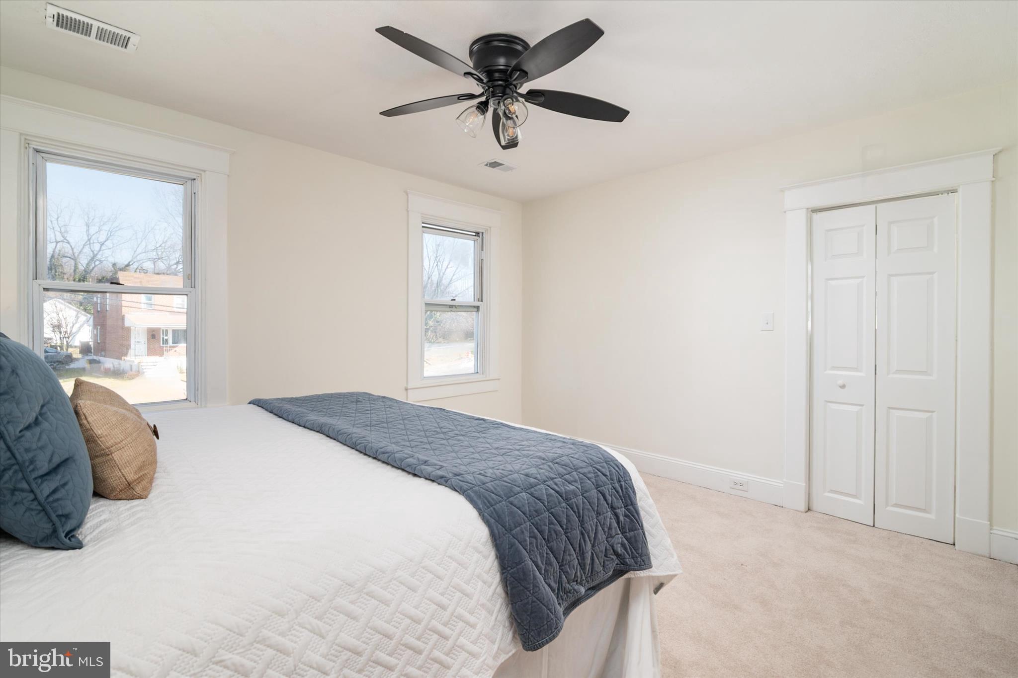 3827 Echodale Avenue Baltimore, MD 21206 - Photo 22 of 36 a bedroom with a bed and a chandelier