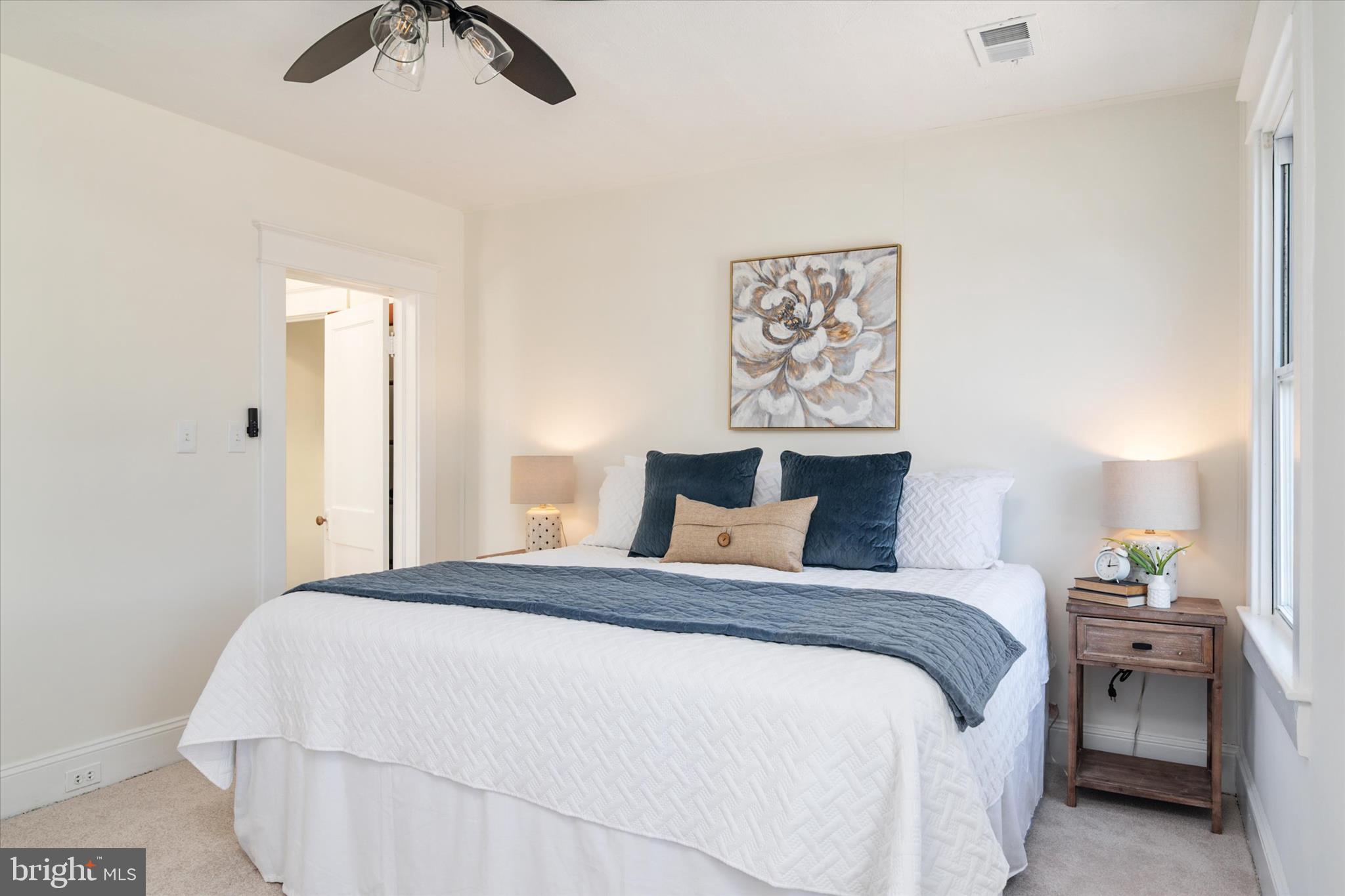 3827 Echodale Avenue Baltimore, MD 21206 - Photo 23 of 36 a bedroom with a bed and a chandelier