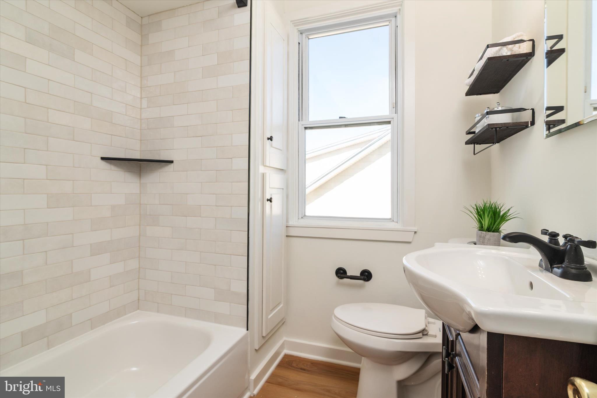 3827 Echodale Avenue Baltimore, MD 21206 - Photo 24 of 36 a bathroom with a sink toilet and shower