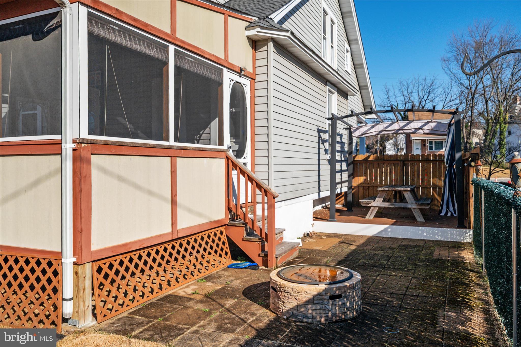 3827 Echodale Avenue Baltimore, MD 21206 - Photo 32 of 36 a view of a patio with table and chairs with wooden floor and fence
